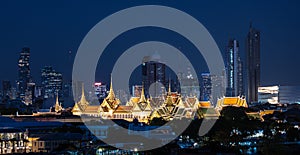 Grand palace and Wat Phra Kaew surround by modern buildings, in Bangkok city Thailand photo