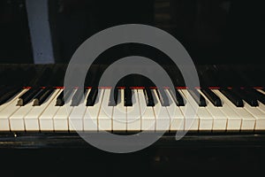 Grand piano has piano key placed in hallroom. this image for mus