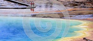 Grand Prismatic Spring with Steam in Yellowstone National Park on Rainy Day with People on the Boardwalk