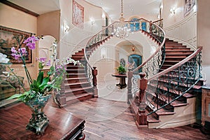 The grand staircase in the entryway of a custom home