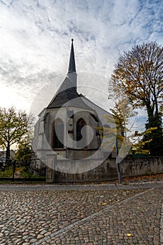 Grand stone edifice featuring an intricately-crafted spire and a sharp-pointed roof in Eilgenburg