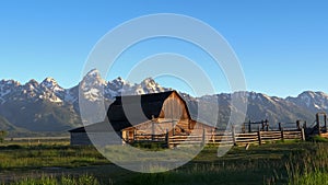 Grand teton and a barn at sunrise in wyoming