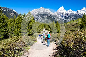 Grand Teton National Park, Jackson Hole, Wyoming, USA, May 31, 2021, Group of hikers on the trail from Taggart Lake