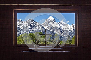 Grand Teton peaks view from the wooden Chapel of Transfiguration window