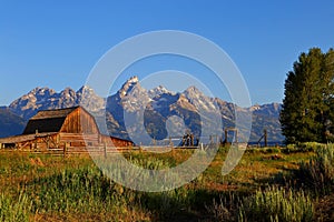 The Grand Teton sunrise reflection at Historic Moulton Barn in Grand Teton National Park,