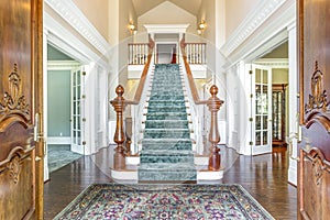 Grand two story foyer with elegant staircase. photo