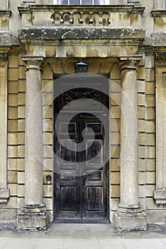 Grand wooden door between stone pillars