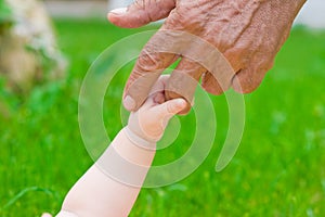 Grandad's and baby's hands