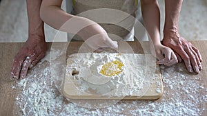 Grandchild and granny cooking traditional cake, little girl adding flour, recipe