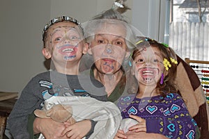 Grandchildren Painting Faces with Grandmother