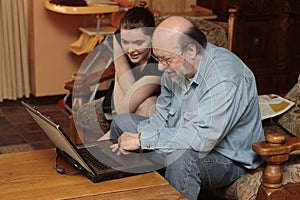 Granddad and grandchild at laptop PC