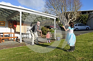 Granddad plays with his daughters outdoor