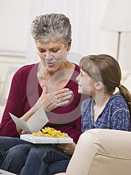 Granddaughter Giving Present to Grandmother