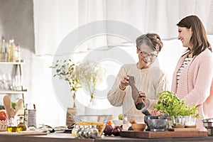 Granddaughter and grandmother cooking