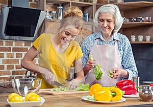 Granddaughter and grandmother cooking together