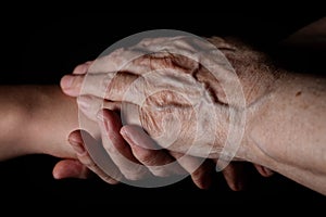 Granddaughter and grandmother holding hands