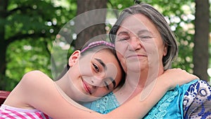 Granddaughter and grandmother smiling at camera