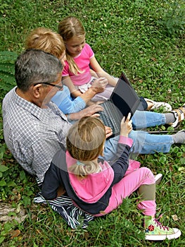 Granddaughter and grandparent with laptop