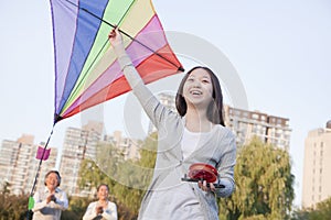 Granddaughter and grandparents with kite in the park