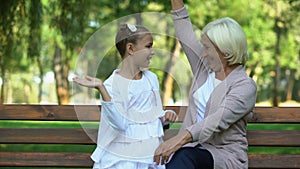 Granddaughter happily running to her grandmother and hugging, family values