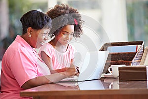 Granddaughter Helping Grandmother With Laptop