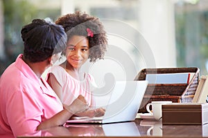 Granddaughter Helping Grandmother With Laptop