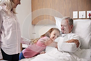 Granddaughter Hugging Grandfather On Family Hospital Visit