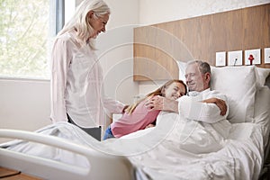 Granddaughter Hugging Grandfather On Family Hospital Visit