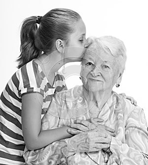 Granddaughter kissing her old grandmother