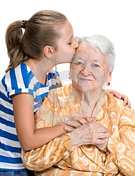 Granddaughter kissing her old grandmother