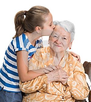 Granddaughter kissing her old grandmother