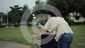 granddaughter pushing senior woman in wheelchair at park