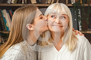 Granddaughter taking care of her retired grandmother kiss