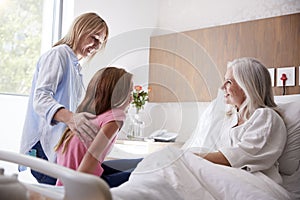 Granddaughter Talking With Grandmother On Family Hospital Visit