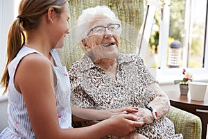 Granddaughter Visiting Grandmother In Lounge Of Retirement Home