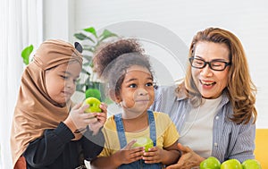 Granddaughters and grandmother enjoying with raw organic green apple, Children and woman biting green apples with smile