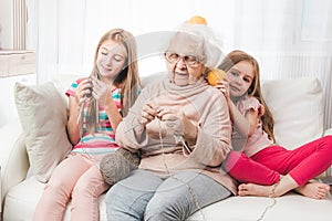 Granddaughters knitting with grandmother