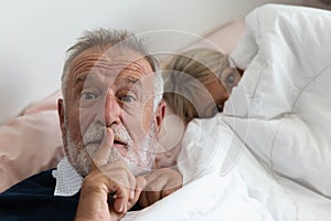 Grandfather ask to keep silence while grandmother is going to sleep
