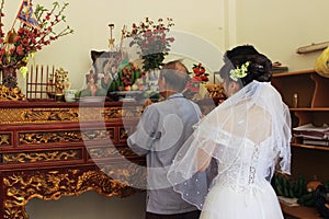 Grandfather with bride and groom are burned incense to forefather in wedding day