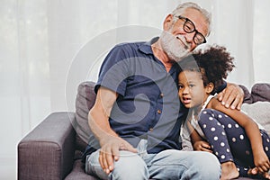 Grandfather embraces hug love for the little girl niece in a warm family home photo