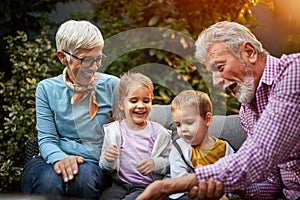 Grandfather entertains grandchildren photo