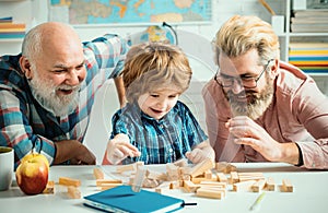 Grandfather father and cute little son having fun at home. Parenting childhood values weekend. Male multi generation