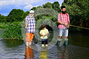 Grandfather, father and grandson fishing together. Grandson with father and grandfather fishing by lake. Father, son and