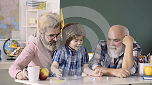Grandfather, father, son playing indoors. Educational games. Private school kids. Child Schoolboy learning numbers.