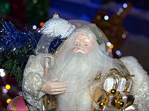 Grandfather Frost Santa Claus, St. Nicholas, Joulupukki with gifts on the against the Christmas tree.