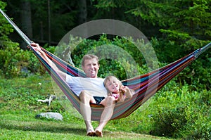 Grandfather and girl in hammock