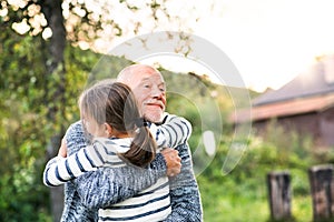 Grandfather giving his grandaughter a hug.