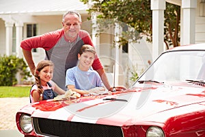 Grandfather With Grandchildren Cleaning Restored Classic Car