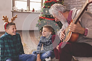 Grandfather and grandchildren singing Christmas songs