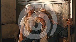 Grandfather and granddaughter in barn